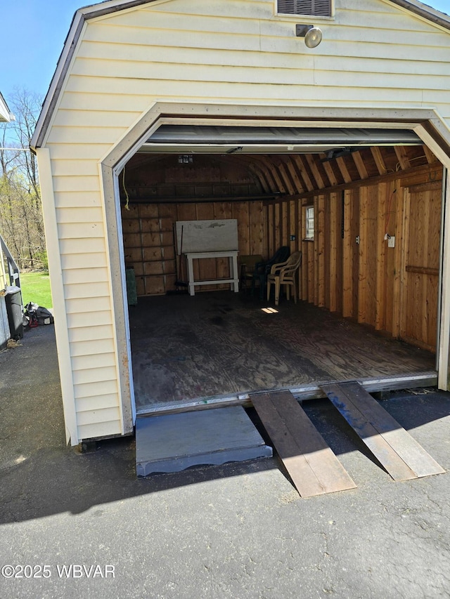 view of parking / parking lot featuring a garage