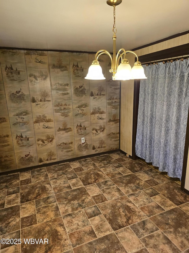 unfurnished dining area with stone finish floor and a chandelier
