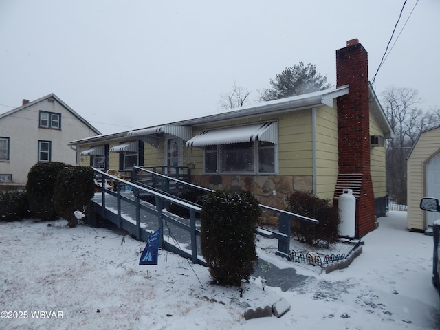 view of front of home featuring a chimney