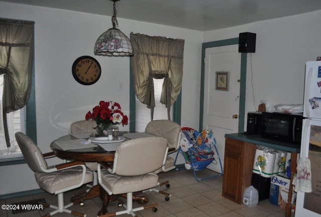 dining room featuring light tile patterned flooring and a healthy amount of sunlight