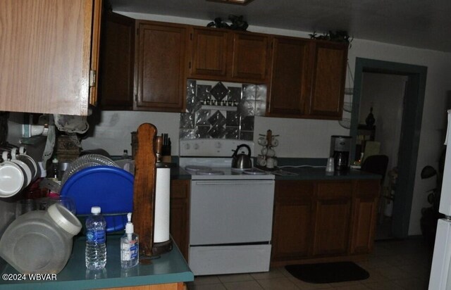 kitchen featuring white range with electric cooktop and light tile patterned floors