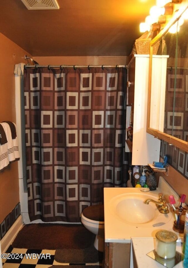 bathroom with vanity, toilet, and walk in shower