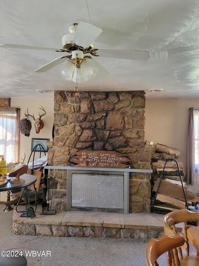 details featuring a textured ceiling, ceiling fan, carpet floors, and a fireplace