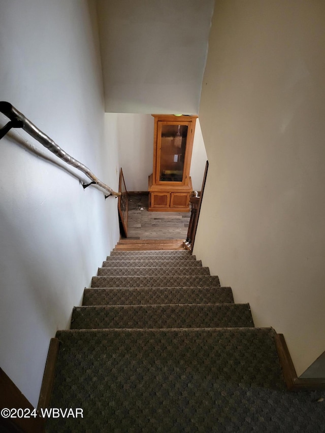 stairs with hardwood / wood-style floors