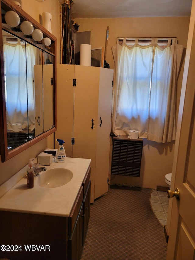 bathroom featuring vanity and toilet