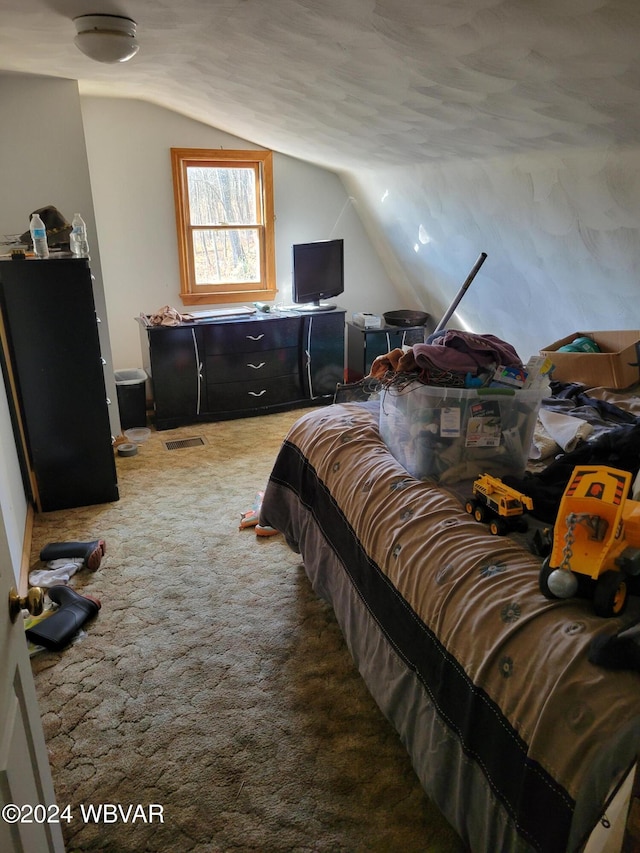 carpeted bedroom with lofted ceiling