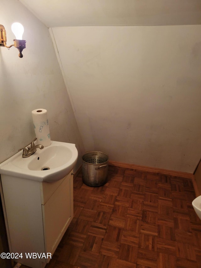 bathroom with parquet flooring and vanity