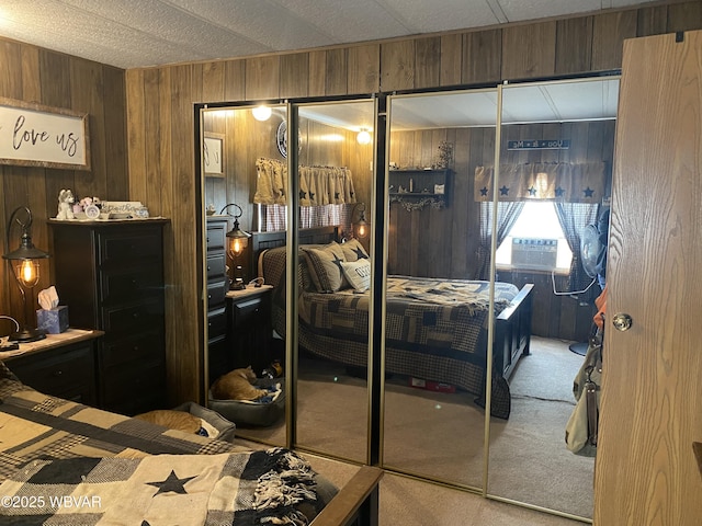 bedroom with wooden walls and carpet