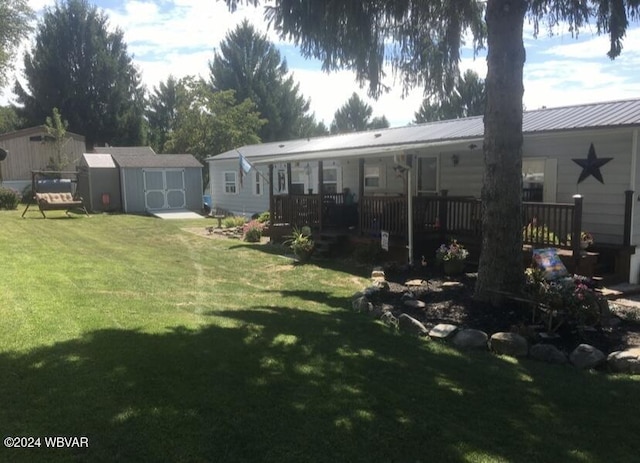 view of yard featuring an outdoor structure, a wooden deck, and a storage unit