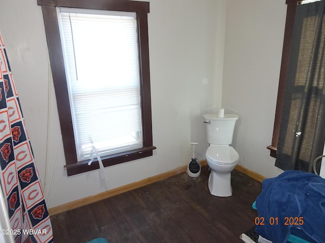 bathroom with hardwood / wood-style flooring and toilet