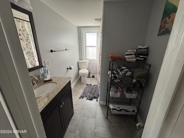 bathroom with tile patterned floors, vanity, and toilet