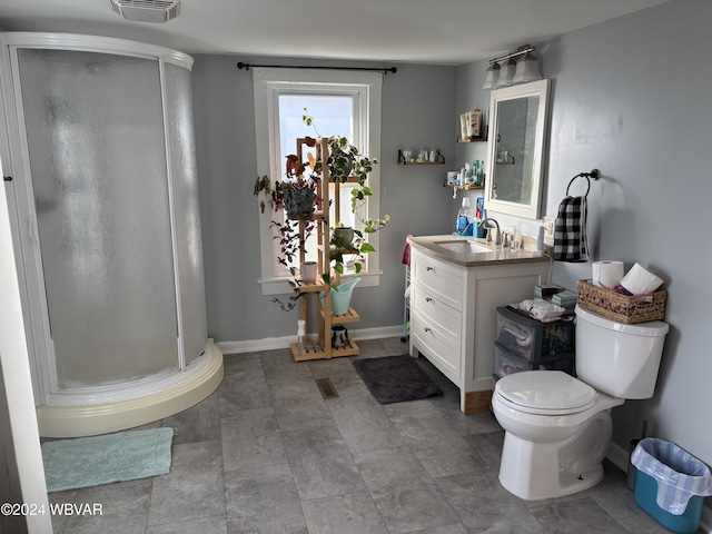 bathroom with vanity, toilet, and an enclosed shower