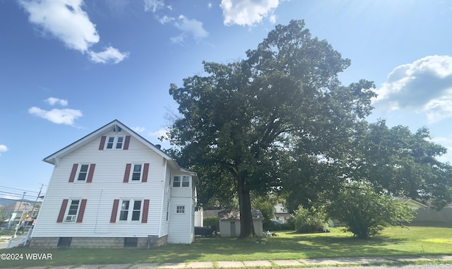 view of home's exterior featuring a shed and a lawn