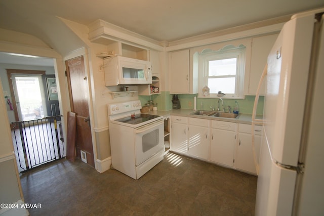 kitchen with decorative backsplash, white appliances, white cabinetry, and sink