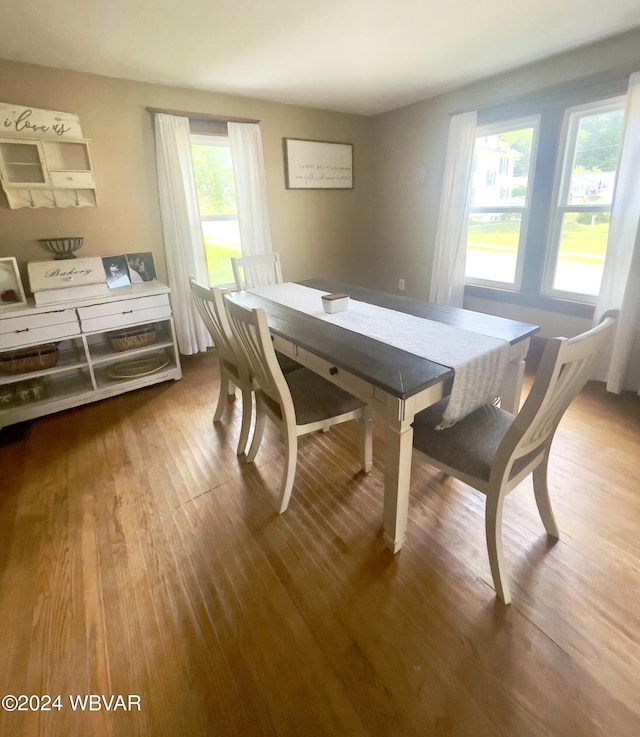 dining space with hardwood / wood-style flooring