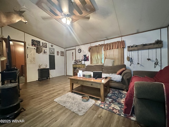 207 Bald Eagle Forest Rd, Blanchard, PA 16826 - living area featuring a wood stove, a ceiling fan, wood finished floors, and vaulted ceiling