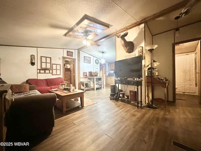 207 Bald Eagle Forest Rd, Blanchard, PA 16826 - living room with ceiling fan, wood finished floors, vaulted ceiling, and a textured ceiling