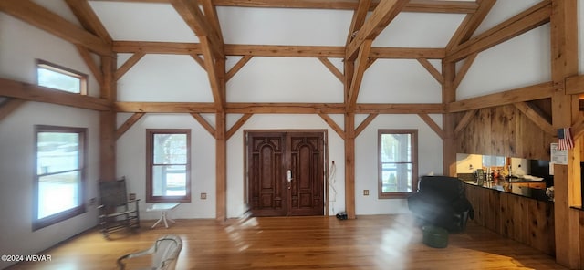 entryway with lofted ceiling and light wood-type flooring