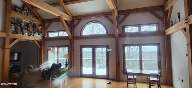 doorway featuring french doors, light hardwood / wood-style floors, and high vaulted ceiling