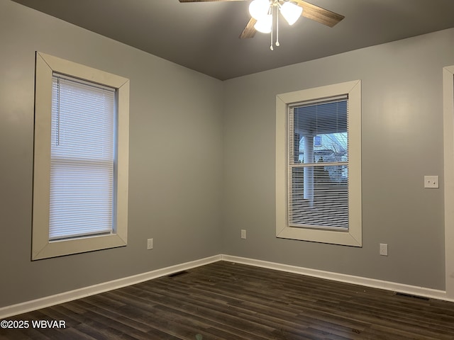 unfurnished room with ceiling fan and dark hardwood / wood-style flooring