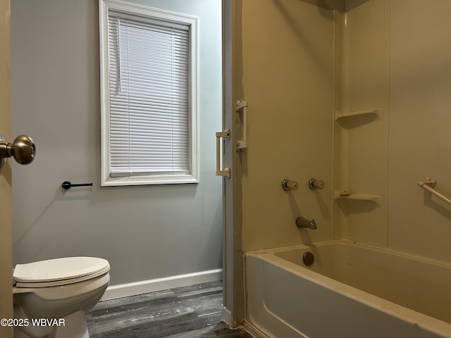 bathroom featuring hardwood / wood-style floors,  shower combination, and toilet