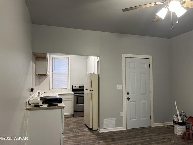 kitchen featuring sink, white cabinets, white refrigerator, dark wood-type flooring, and electric stove