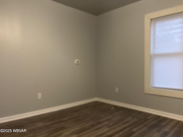 spare room with dark hardwood / wood-style flooring