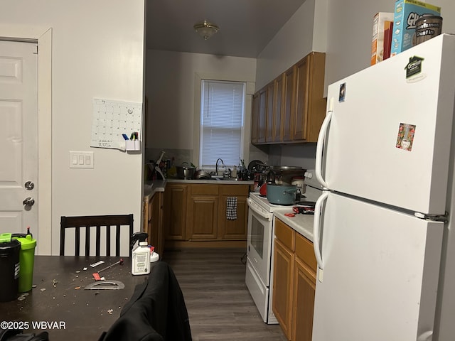 kitchen featuring sink, white appliances, and dark hardwood / wood-style floors