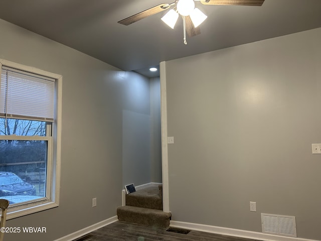 spare room featuring ceiling fan and dark hardwood / wood-style flooring