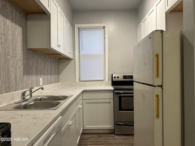 kitchen with stainless steel appliances, sink, and white cabinets