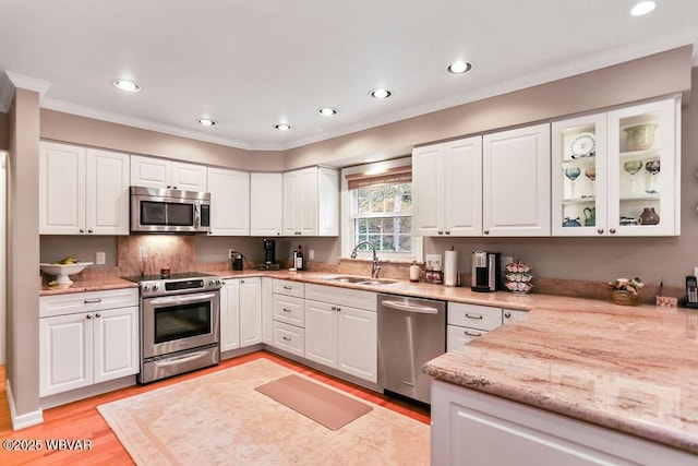 2528 N Hills Dr, Williamsport, PA 17701 - kitchen with light stone counters, white cabinetry, light wood-style floors, stainless steel appliances, and a sink
