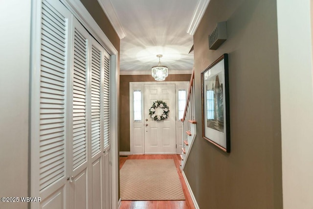 2528 N Hills Dr, Williamsport, PA 17701 - entryway featuring a chandelier, light wood-style floors, baseboards, and ornamental molding