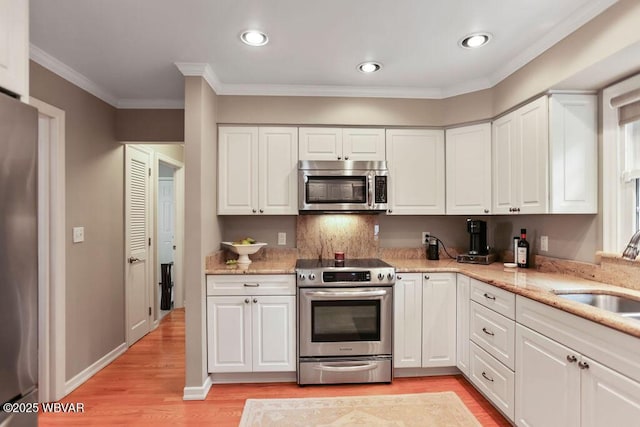 2528 N Hills Dr, Williamsport, PA 17701 - kitchen featuring light wood-type flooring, appliances with stainless steel finishes, a sink, and white cabinetry