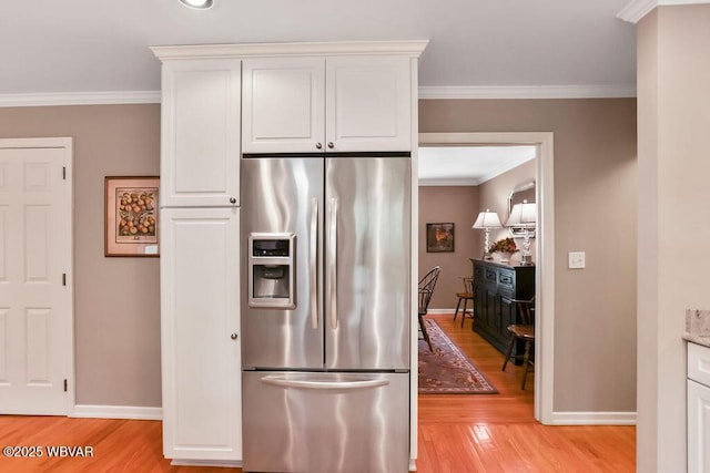 2528 N Hills Dr, Williamsport, PA 17701 - kitchen with light wood-style floors, ornamental molding, white cabinets, stainless steel fridge, and baseboards