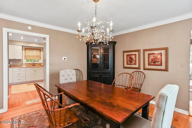 2528 N Hills Dr, Williamsport, PA 17701 - dining area with light wood-style flooring, baseboards, an inviting chandelier, and ornamental molding