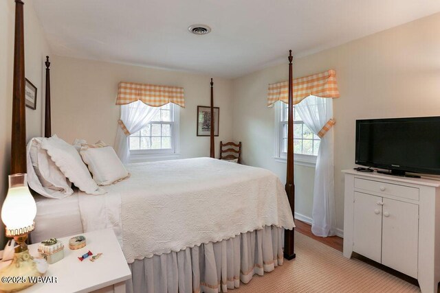 2528 N Hills Dr, Williamsport, PA 17701 - bedroom featuring visible vents, baseboards, multiple windows, and light wood-style floors