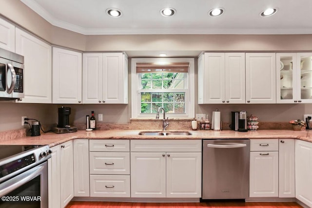 2528 N Hills Dr, Williamsport, PA 17701 - kitchen with stainless steel appliances, white cabinets, a sink, and crown molding