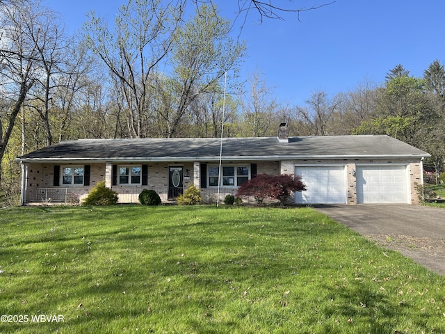 ranch-style house with a chimney, a front lawn, aphalt driveway, an attached garage, and brick siding