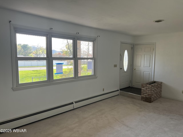 entrance foyer featuring carpet, a healthy amount of sunlight, and baseboard heating