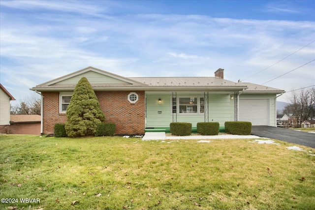 single story home with a front lawn, covered porch, and a garage