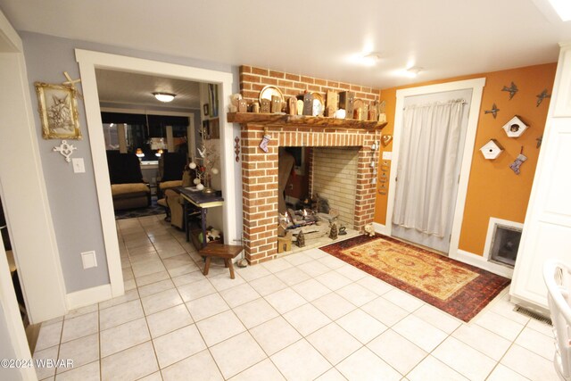 tiled living room featuring a brick fireplace