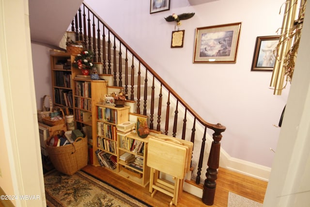 staircase with hardwood / wood-style flooring