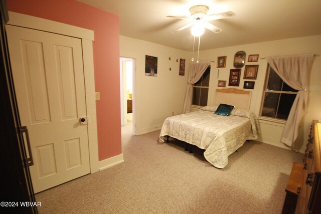 bedroom with ceiling fan and light colored carpet