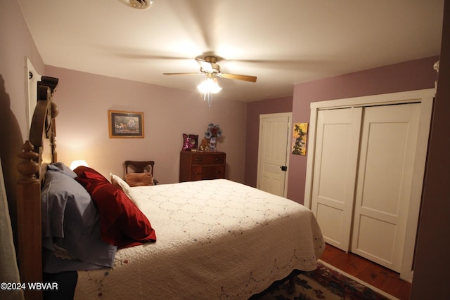 bedroom with ceiling fan, dark wood-type flooring, and a closet