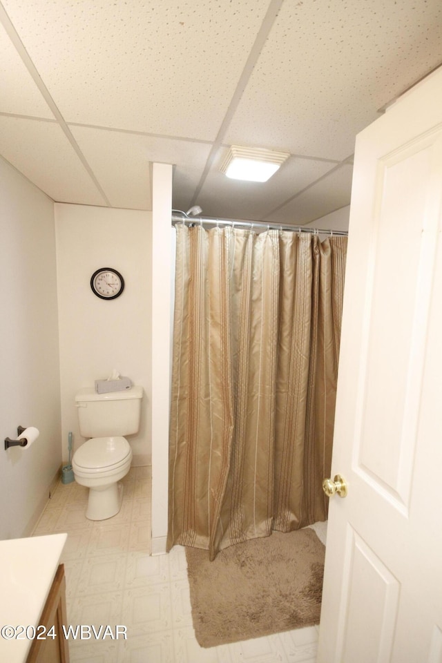 bathroom featuring vanity, a paneled ceiling, and toilet