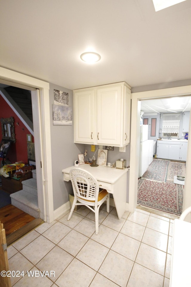 laundry area featuring washing machine and clothes dryer and light tile patterned floors