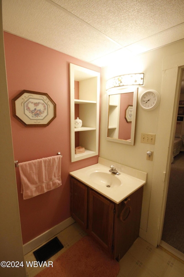 bathroom with a textured ceiling and vanity