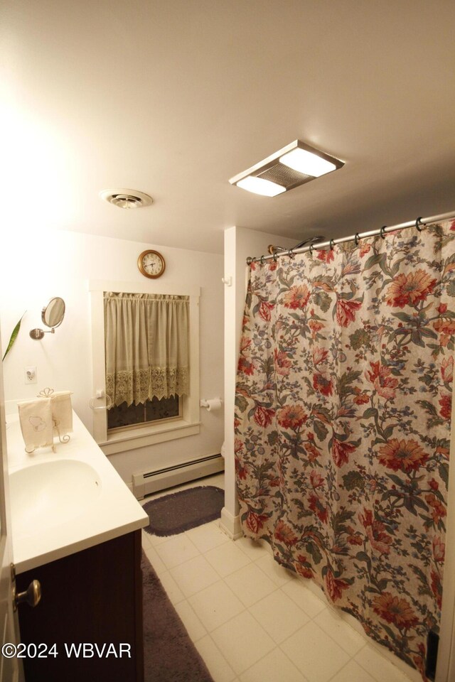 bathroom featuring tile patterned floors, vanity, and a baseboard heating unit