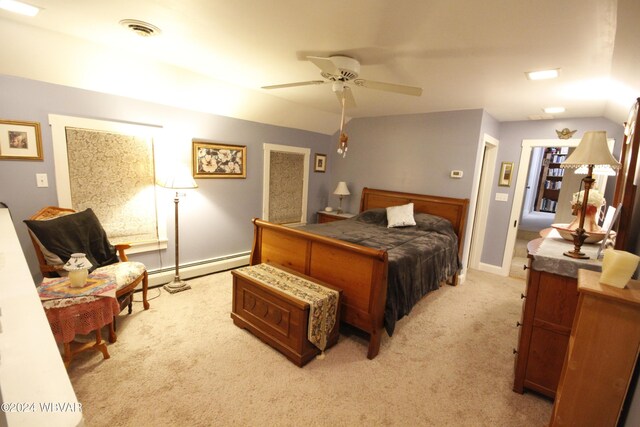 carpeted bedroom with ceiling fan, vaulted ceiling, and a baseboard radiator