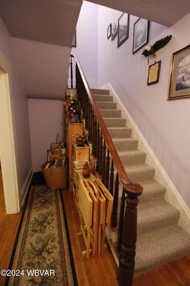 staircase featuring hardwood / wood-style floors